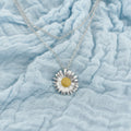 A stainless steel daisy necklace with a textured yellow center. Daisy Bloom Memorial Pendat at Tilly&Co Memorial Jewellery. 