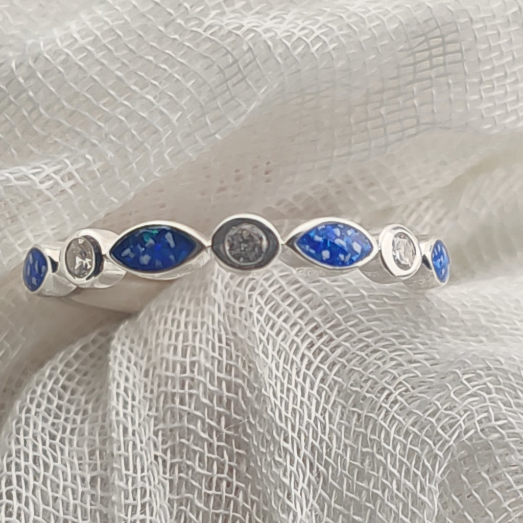 925 sterling silver marquise ring with blue stones on a textured white background