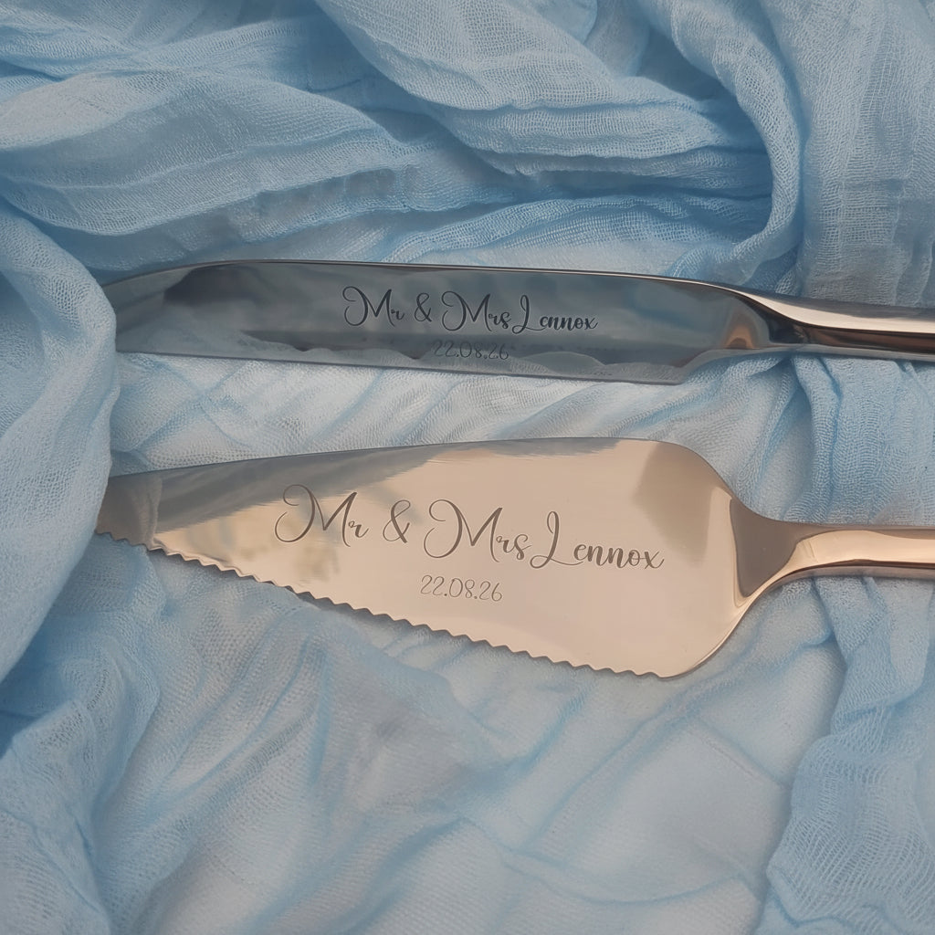 Two personalized cake knives with scalloped edges, engraved with 'Mr & Mrs Lennox' and the date '22.08.