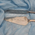 Two personalized cake knives with scalloped edges, engraved with 'Mr & Mrs Lennox' and the date '22.08.