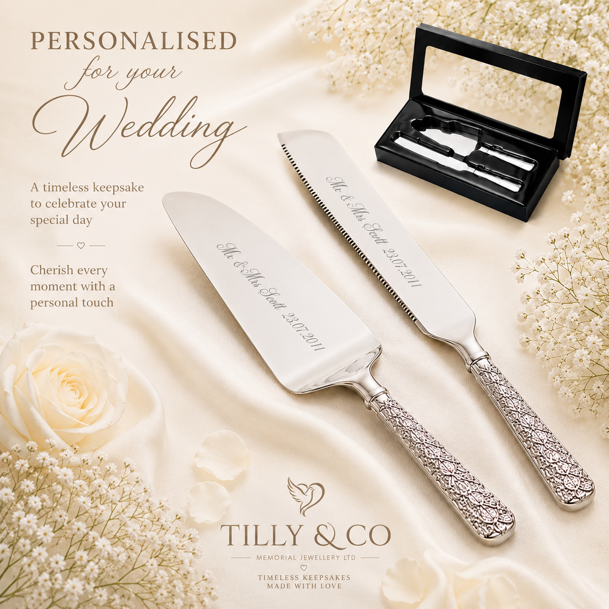 Personalized wedding cake and server set by Tilly & Co, featuring a silver cake knife and matching server with ornate handles, displayed on a cream satin fabric with white roses and baby's breath. A black presentation box with a mirror is shown in the upper right, and promotional text appears on the left.