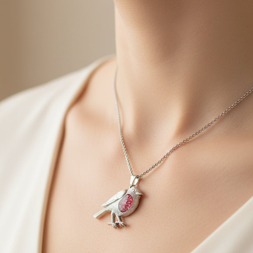 Robin shaped pendant with a red opal memorial stone on model.