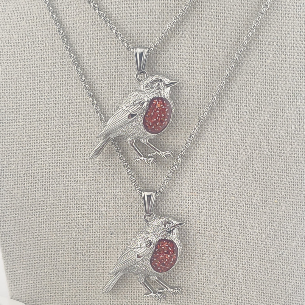 Two Robin pendants with red memorial stones with ashes