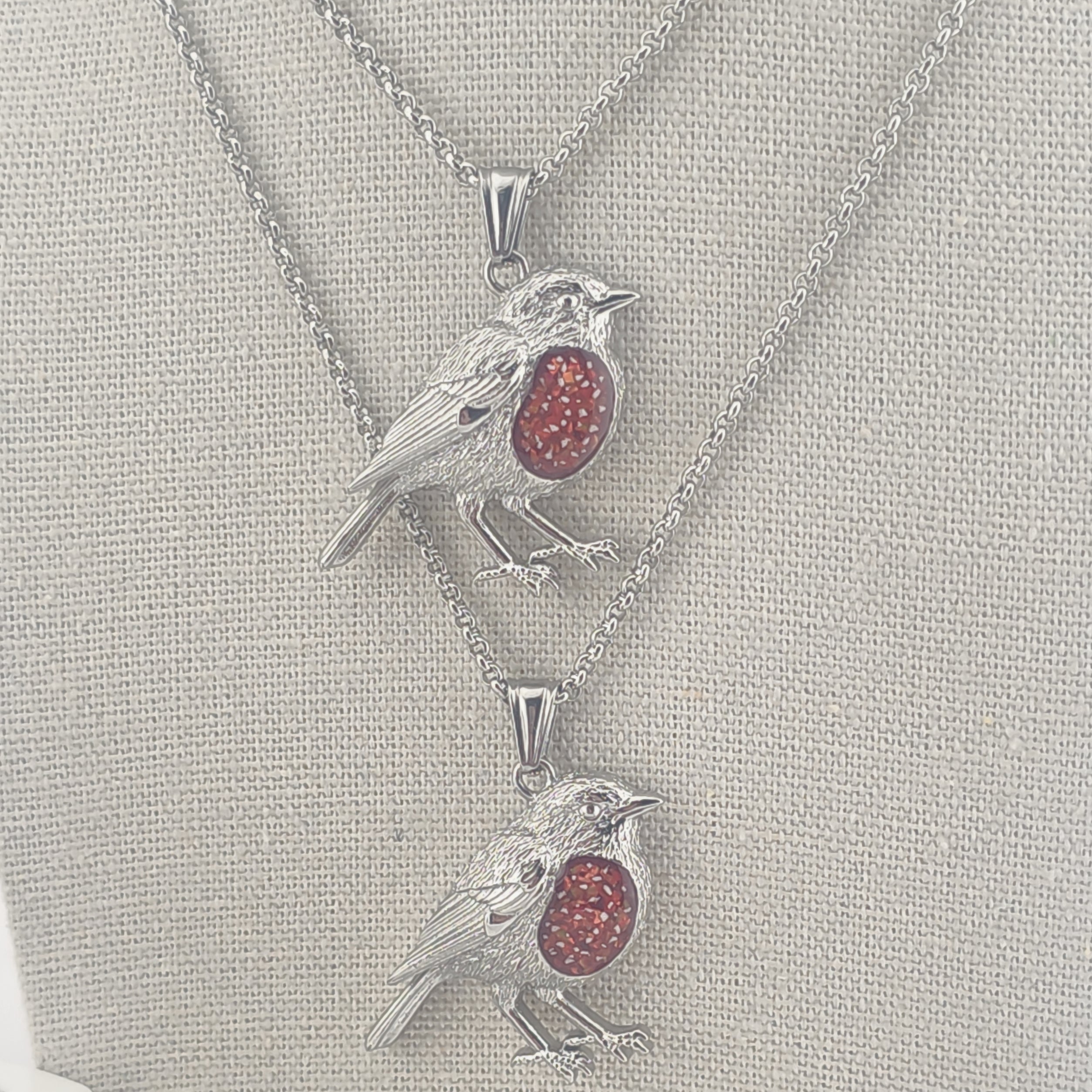 Two Robin pendants with red memorial stones with ashes