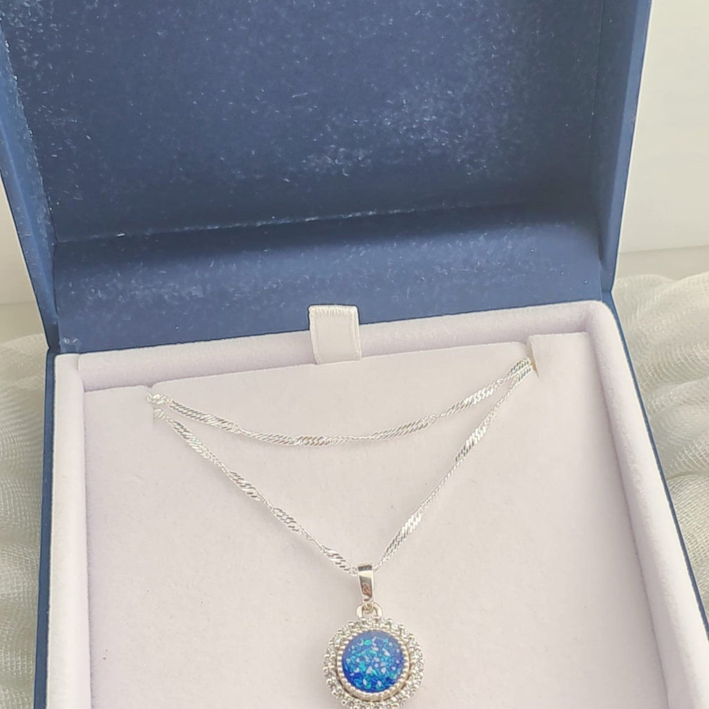 Tilly & Co Memorial Jewellery Ltd Celestia sterling silver halo pendant with blue resin and crystal in a gift box