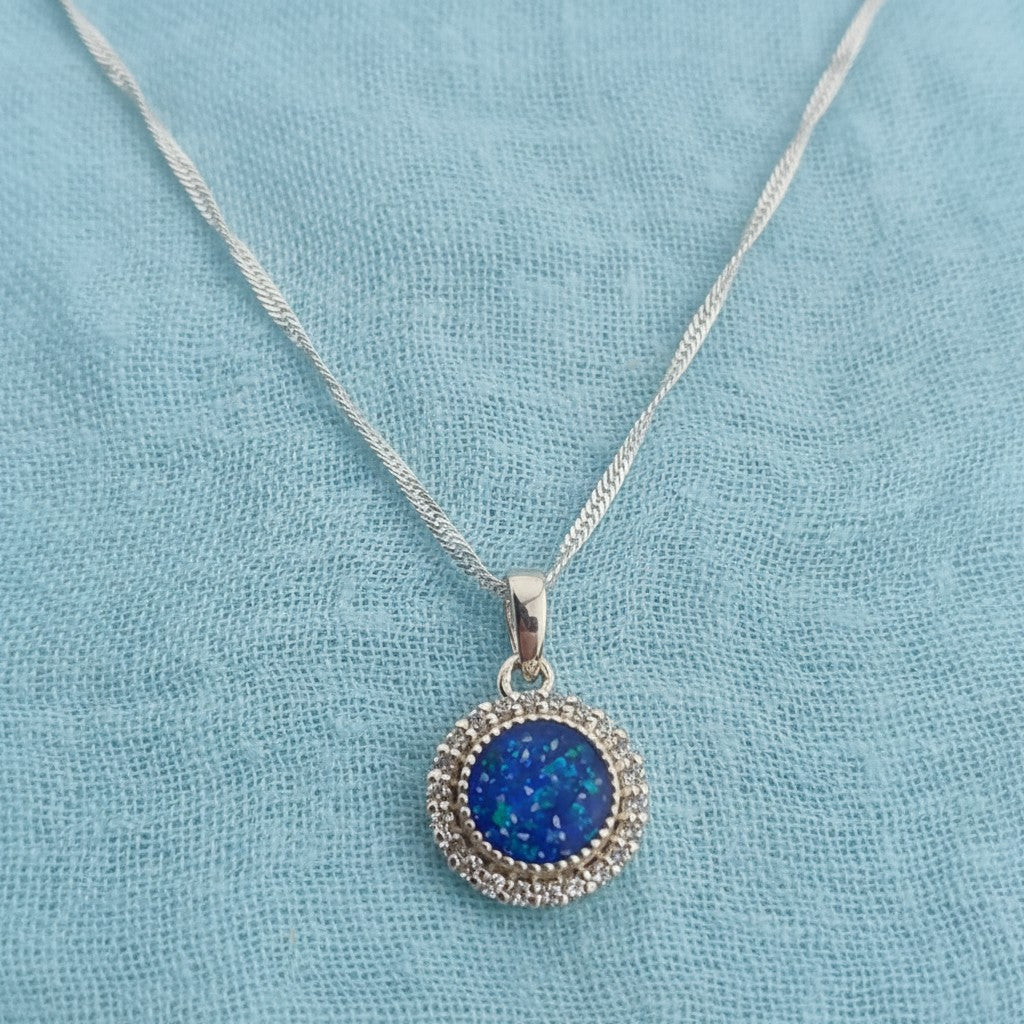 Tilly & Co Memorial Jewellery Ltd Celestia sterling silver pendant with a blue resin centre and crystal halo setting.